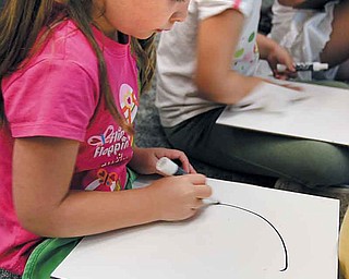 Eliyanna Shank, enrolled in one of two Success By 6 pre-kindergarten summer classes at Market Street Elementary School in Boardman, draws an “A.” Success By 6, a program sponsored by the United Way of Youngstown and the Mahoning Valley, received a $53,000 donation from the John S. and Doris M. Andrews Fund.