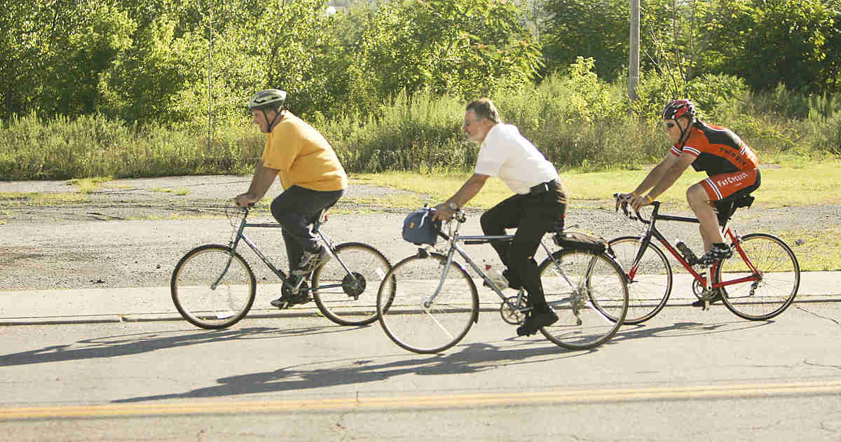 ROBERT K. YOSAY | THE VINDICATOR... Lonely on the road as the crew heads north on Poland Ave.  almost into downtown ..Ride to work with Franko...Frank Krygowski-- White shirt -- Carl Frost - Orange and Black - Todd Franko in Orange -30-