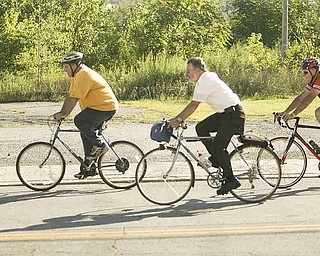 ROBERT K. YOSAY | THE VINDICATOR... Lonely on the road as the crew heads north on Poland Ave. almost into downtown ..Ride to work with Franko...Frank Krygowski-- White shirt -- Carl Frost - Orange and Black - Todd Franko in Orange -30-