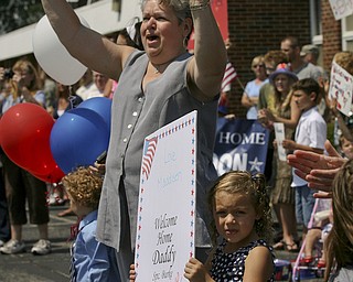 JESSICA M. KANALAS | THE VINDICATOR..As the buses roll in, Maddisen Burke, 5, of Boardman stands by her grandmother ready to welcome home her father, Sgt. Michael Burke of the 292nd Engineer Detachment of the Ohio National Guard.... -30-