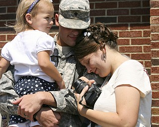 JESSICA M. KANALAS | THE VINDICATOR..Elly Fenstemaker, 3, of Louisville sits in the arms of her father, Spc. Daniel Fenstemaker, who is embraced by his wife, Autumn.... -30-