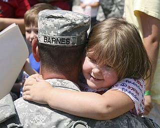 JESSICA M. KANALAS | THE VINDICATOR..Sgt. Chris Barnes of Norwolk embraces his daughter, Halle, 4, after stepping off the buses. .... -30-
