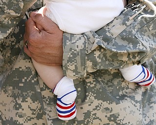 JESSICA M. KANALAS | THE VINDICATOR..Sgt. Roy Mitchell holds his four-month-old son, Roy IV, upon his return to his family. ... -30-