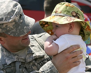 JESSICA M. KANALAS | THE VINDICATOR..Sgt. Roy Mitchell holds his four-month-old son, Roy IV, upon his return to his family. ... -30-