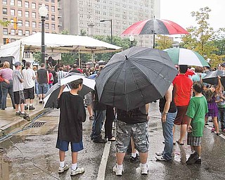 Attendees of the eighth Vex Fest stand beneath umbrellas as Youngstown band Love Turns Hate took the stage. Sunday’s event featured bands from a wide range of states such as New York and California.