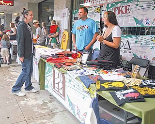 Kate Butler, 27, right and friend Mark Griffin, 28, sell Rusty Waters T-shirts during the Vex Fest on Sunday. Butler, a Youngstown native, cofounded the company in 2005 promoting the grit of Rust Belt cities.