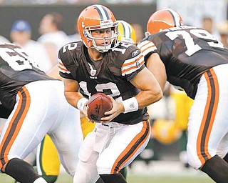 Cleveland Browns quarterback Colt McCoy turns to hand off the ball against the Green Bay Packers in the first quarter of their preseason NFL football game on Saturday, Aug. 13, 2011, in Cleveland.  (AP Photo/Tony Dejak)