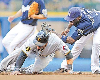 Pittsburgh Pirates' Xavier Paul, left, steals second base in the seventh inning of a baseball game ahead of the tag by the Milwaukee Brewers' Yuniesky Betancourt, right, Sunday, Aug 14, 2011, in Milwaukee.  (AP Photo/Jeffrey Phelps)