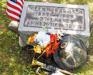 Reagan Moon of Louisiana sounded taps at the grave of the grandfather he never met, Willis William Barris Jr. of Poland, a World War I rifleman, who is buried in Poland Riverside Cemetery. Barris died in a car crash at 32. Shown in front of Barris’ headstone is his WWI helmet and the bugle Moon used to honor his grandfather.