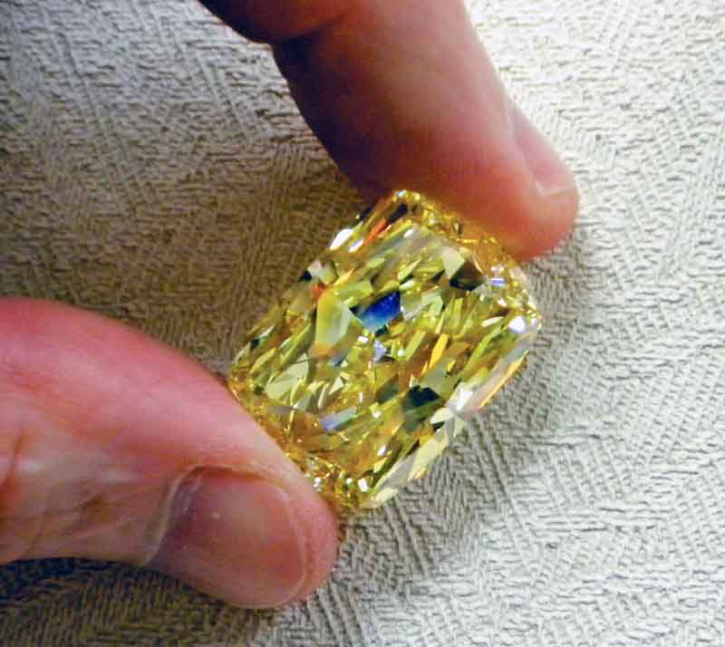 This undated photo provided by the U.S. Marshals Service shows a large yellow diamond.  The large yellow diamond, known as the “Golden Eye,” was seized in a federal drug and money laundering investigation in northeast Ohio and is going on the auction block with the minimum bid to start at $900,000. The 43.51 carat diamond belonged to an Ohio businessman convicted of money laundering and conspiracy. A refundable deposit of $180,000 is required to be able to view the diamond in Cleveland the week of Aug. 29-Sept. 2 and bid on it during the auction that begins at 8 a.m. on Sept. 6 and continues until 3 p.m. Sept. 8. (AP Photo/U.S. Marshals Service)
