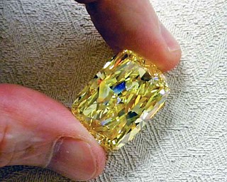 This undated photo provided by the U.S. Marshals Service shows a large yellow diamond.  The large yellow diamond, known as the “Golden Eye,” was seized in a federal drug and money laundering investigation in northeast Ohio and is going on the auction block with the minimum bid to start at $900,000. The 43.51 carat diamond belonged to an Ohio businessman convicted of money laundering and conspiracy. A refundable deposit of $180,000 is required to be able to view the diamond in Cleveland the week of Aug. 29-Sept. 2 and bid on it during the auction that begins at 8 a.m. on Sept. 6 and continues until 3 p.m. Sept. 8. (AP Photo/U.S. Marshals Service)