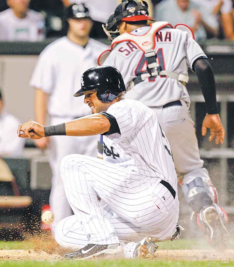 The Chicago White Sox's Alex Rios scores on a single hit by Tyler Flowers during the fourth inning of their baseball game against the Cleveland Indians in Chicago, Thursday, Aug. 18, 2011. (AP Photo/Nam Y. Huh)