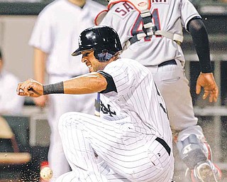 The Chicago White Sox's Alex Rios scores on a single hit by Tyler Flowers during the fourth inning of their baseball game against the Cleveland Indians in Chicago, Thursday, Aug. 18, 2011. (AP Photo/Nam Y. Huh)
