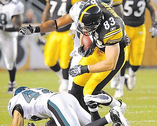 Pittsburgh Steelers tight end Heath Miller (83) tumbles over Philadelphia Eagles safety Kurt Coleman (42) after making a catch in the first quarter of the NFL preseason football game on Thursday, Aug. 18, 2011 in Pittsburgh. (AP Photo/Donald Wright)