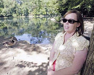 Kirsten Peetz, environmental-land manager for Mill Creek MetroParks, discusses why the park system put up six signs discouraging visitors from feeding the waterfowl at the Lily Pond in Youngstown.