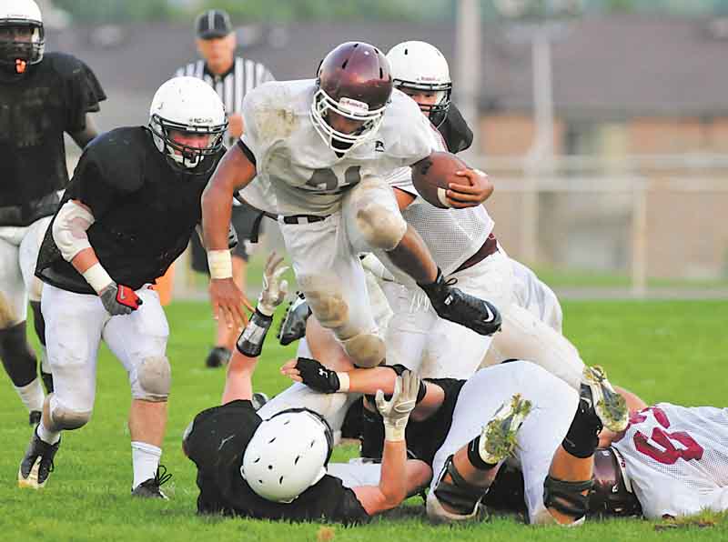 Boardman running back #21 Devin Campbell hurdles over a would be Howland tackler during a scrimmage Friday night.
