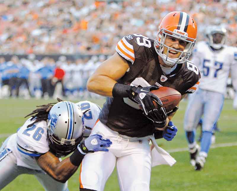 Cleveland Browns tight end Evan Moore (89) catches a 2-yard touchdown pass against Detroit Lions safety Louis Delmas (26) in the first quarter of an NFL preseason football game Friday, Aug. 19, 2011, in Cleveland. (AP Photo/Tony Dejak)