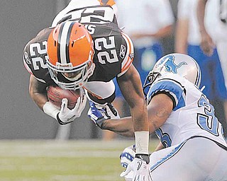 Cleveland Browns' Buster Skrine (22) is upended by Detroit Lions cornerback Paul Pratt on a first-quarter kick return in a preseason NFL football game Friday, Aug. 19, 2011, in Cleveland. (AP Photo/Amy Sancetta)