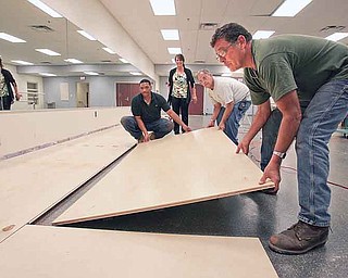Chaney High School in Youngstown opens as a Science, Technology, Engineering and Math and visual- and performing-arts school for sixth- through 12th-graders this year. Workers last week laid a dance floor in what used to be the school’s weight room.
