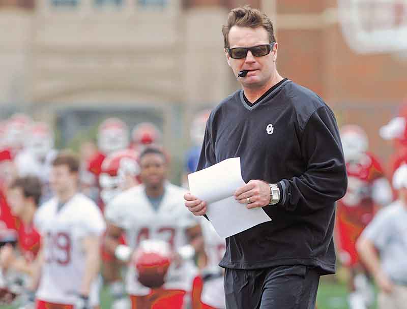 FILE - In this March 21, 2011 file photo, Oklahoma football coach Bob Stoops oversees the first day of spring NCAA college football practice in Norman, Okla. (AP Photo/Sue Ogrocki, File)