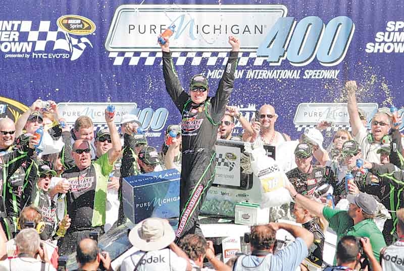 Kyle Busch celebrates his victory in the NASCAR Sprint Cup Series auto race at Michigan International Speedway in Brooklyn, Mich., on Sunday.