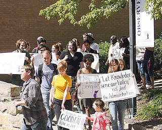 Youngstown State University students carry signs to Williamson Hall, where contract negotiations with faculty resumed Monday afternoon.