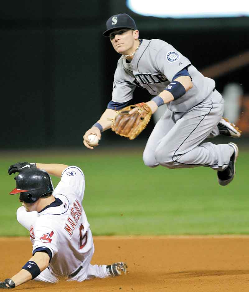 Seattle Mariners second baseman Dustin Ackley avoids Cleveland Indians' Lou Marson (6) but can't relay to first to complete a double play on Indians' Ezequiel Carrera in the seventh inning of a baseball game Monday, Aug. 22, 2011, in Cleveland. (AP Photo/Mark Duncan)
