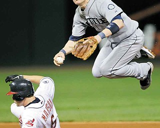 Seattle Mariners second baseman Dustin Ackley avoids Cleveland Indians' Lou Marson (6) but can't relay to first to complete a double play on Indians' Ezequiel Carrera in the seventh inning of a baseball game Monday, Aug. 22, 2011, in Cleveland. (AP Photo/Mark Duncan)