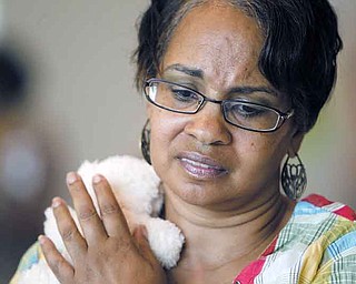 Kay White consoles her “child,” simulated by a stuffed animal, as she is given bad news that the pawn shop isn’t interested in her furniture and will pay for only one of her two microwaves. White was portraying a single, 19-year-old mother Monday during the poverty simulation at East High School.