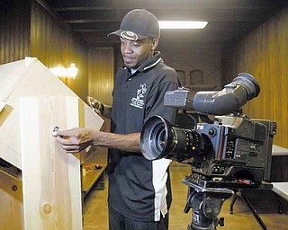 Filmmaker Brian West of the Method 8 Corp. sets up his equipment before shooting at Pioneer Pavilion in Mill Creek MetroParks. His movie “Miracle: The Land of Escobar Part One” is based on a story he authored.
