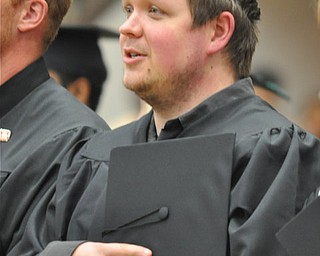 Graduate from the 2011 YSU Summer commencement places his cap above his heart as he begins singing the National Anthem....Photo By: Lindsay Y McCall | The Vindicator