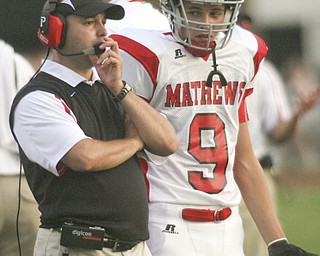 ROBERT K. YOSAY | THE VINDICATOR --..Jim Tressel night as coach David Harries of Mathews donned the sweater vest as he talks with Mathews #9 Cody Parthemer --Western Reserve Blue Devils vs Mathews Mustangs at Western Reserve Stadium Thursday night .--30-..(AP Photo/The Vindicator, Robert K. Yosay)