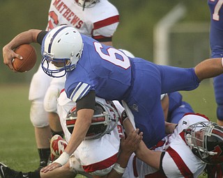 ROBERT K. YOSAY | THE VINDICATOR --..Going for more as Western ReserveQB #6 Jeff Clegg dives over Mathews Defenders for a few extra yards during first half action at Western Reserve Stadium --- Western Reserve Blue Devils vs Mathews Mustangs at Western Reserve Stadium Thursday night .--30-..(AP Photo/The Vindicator, Robert K. Yosay)