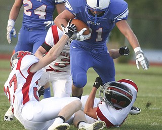 ROBERT K. YOSAY | THE VINDICATOR --..#3 Tommy Marlowe is brought down by a #27 Mathes Ryan Mazey #3 Craig Hunter and #50 Chase Ramsey -- Western Reserve Blue Devils vs Mathews Mustangs at Western Reserve Stadium Thursday night .--30-..(AP Photo/The Vindicator, Robert K. Yosay)