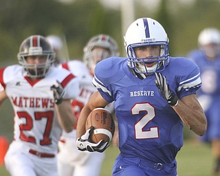 ROBERT K. YOSAY | THE VINDICATOR --..#2 Donnie Bolton for Western Reserve takes the ball 85 yards in his first of two touchdowns in the first quarter. the last man he beat was mathews #27 Ryan Mazey---Western Reserve Blue Devils vs Mathews Mustangs at Western Reserve Stadium Thursday night .--30-..(AP Photo/The Vindicator, Robert K. Yosay)