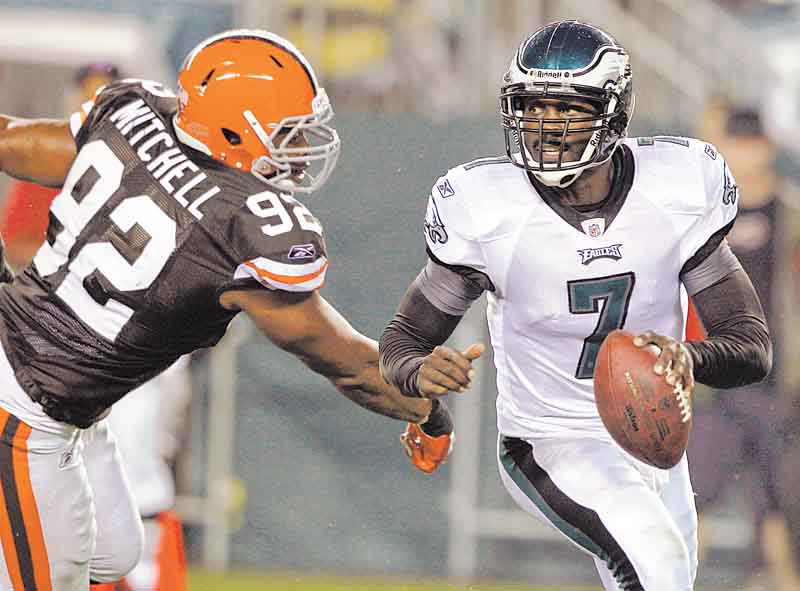 Philadelphia Eagles quarterback Michael Vick (7) scrambles away from Cleveland Browns defensive end Jayme Mitchell (92) during the first half of a preseason NFL football game on Thursday, Aug. 25, 2011, in Philadelphia. (AP Photo/Matt Rourke)
