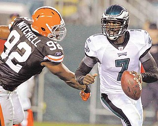 Philadelphia Eagles quarterback Michael Vick (7) scrambles away from Cleveland Browns defensive end Jayme Mitchell (92) during the first half of a preseason NFL football game on Thursday, Aug. 25, 2011, in Philadelphia. (AP Photo/Matt Rourke)