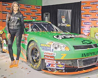 Driver Danica Patrick displays the car that she will drive full-time in the NASCAR Nationwide Series circuit and select Sprint Cup races during an auto racing news conference Thursday, Aug 25, 2011, in Scottsdale, Ariz.  After months of skirting speculation, Patrick announced Thursday that she's leaving IndyCar in 2012 to run a full Nationwide schedule with JR Motorsports and up to 10 Sprint Cup races for Stewart-Haas Racing.  (AP Photo/Paul Connors)