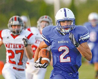 Western Reserve’s Donnie Bolton (2) sprints past Mathews Ryan Mazey (27) on an 85-yard touchdown run in the fi rst quarter of Thursday’s season opener at Western Reserve Stadium. Bolton scored three times for the Blue Devils, who dominated the Mustangs, 52-19.