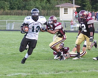 FOOTBALL - George Leflore of East breaks away from (22) Frank Bond for a long gain during thier game Friday night in Liberty. - Special to The Vindicator/Nick Mays