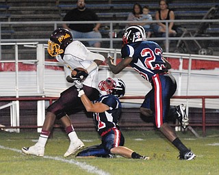 John Adams #1Tevin Griffin is tackled after making an interception by Niles players #11L.J. Cox and #23 Darius Harris.