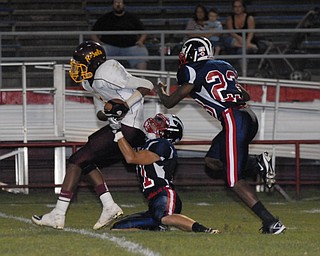 John Adams #1Tevin Griffin is tackled after making an interception by Niles players #11L.J. Cox and #23 Darius Harris.