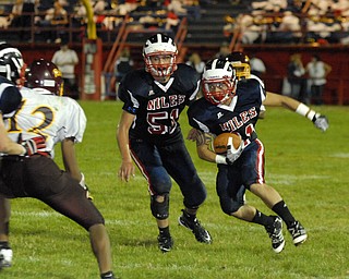 Niles defensive back #11 L.J. Cox looks for a block from teammate #51Brett Spencer after making an interception.