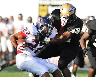 Austintown Fitch running back #22 Chris Davis tries to slip the tackle of Warren Harding's #33 Aundra'ez Cambridhge.