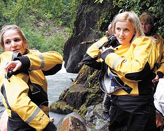 In this photo taken Aug. 18, 2011, ,Julie Robinson of Ligonier, Pa., left, and Jennifer Hankins of San Diego, put on wet suits before a white water rafting trip on Crow Creek, near Girdwood, Alaska during an Alaska Adventure excursion. The event was organized by Tragedy Assistance Program for Survivors for a group of about 75 widows of military veterans to share memories of loved ones while while hiking rugged trails and rafting the rapids. (AP Photo/Mark Thiessen)