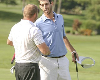 JESSICA M. KANALAS | THE VINDICATOR..Anthony Conn shakes the hand of fellow golfer Josh Zarlenga after winning the 2011 Greatest Golfer of the Valley tournament. Conn and Zarlenga were not only competitors, but also roommates.