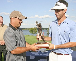 JESSICA M. KANALAS | THE VINDICATOR...Pete Mollica Jr., son of the late Vindicator sports writer Pete Mollica hands the winning trophy to Anthony Conn of Mill Creek Golf Course, giving Conn the 2011 Greatest Golfer of the Valley Champion title... -30-