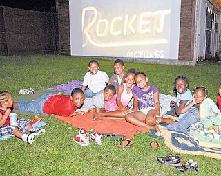 JESSICA M. KANALAS | THE VINDICATOR..Children from the community gather on blankets to watch the showing of "Gnomeo and Juliet."  .. -30-