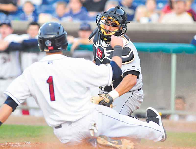Base runner #1 Tony Wolters of Mahoning Valley slides into home plate before Jamestown catcher #12 Eddie Rodriguez.