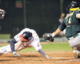 Ezequiel Carrera, left, of the Indians scores ahead of the tag from Athletics catcher Kurt Suzuki in the sixth inning of Monday’s game. Carrera scored on a double by Kosuke Fukudome.